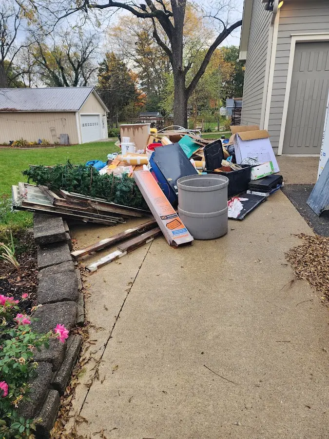 Dumpster being loaded with debris for 12 Yard Dumpster Rental in Bethalto
